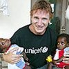 Liam Neeson holds twin brothers during his visit to Mozambique in 2005.
