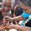 A young baby receives polio vaccine during drive to eradicate disease