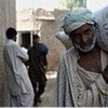 Flood-affected farmer carries away wheat seeds donated by US and distributed by FAO