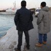 Italian immigration lawyers await the arrival of migrants at the port of Lampedusa