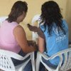 A UNHCR staff member (right) listens to the story of a commercial sex worker in Esmeraldas, Ecuador