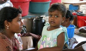 A young girl and her mother at a displaced persons camp in Vavuniya, Sri Lanka (2009).