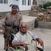 A returnee couple outside their new home in southern Kyrgyzstan