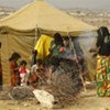 Yemeni women and children tend to a fire in the UN-serviced IDP camp at Mazrak, north Yemen