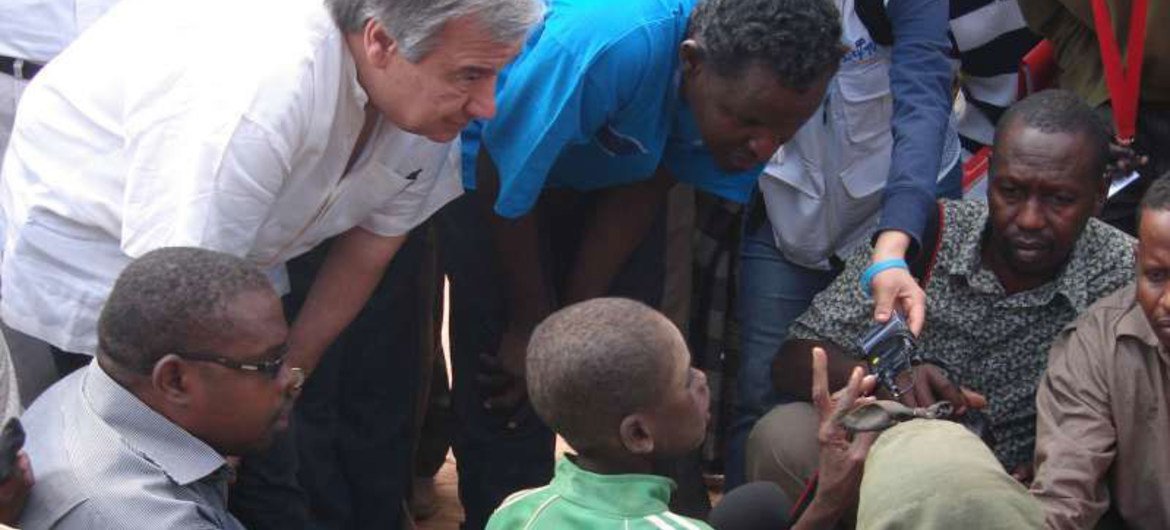 UNHCR chief António Guterres (left, crouching) chats with Somali refugees in Ifo camp at Dadaab, northern Kenya