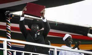 President Salva Kiir of the Republic of South Sudan shows a copy of the interim constitution of his new nation