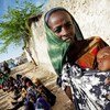 A Somali woman and her severely malnourished child wait for medical assistance from the African Union Mission in Somalia