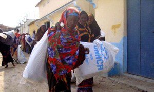 These displaced Somali women head back to their families carrying aid distributed in Mogadishu.