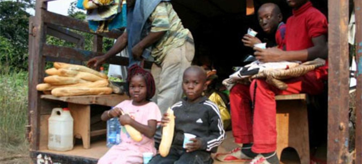 Members of the Pepidi family take a lunch break during their long trip home to the Republic of Congo from Gabon