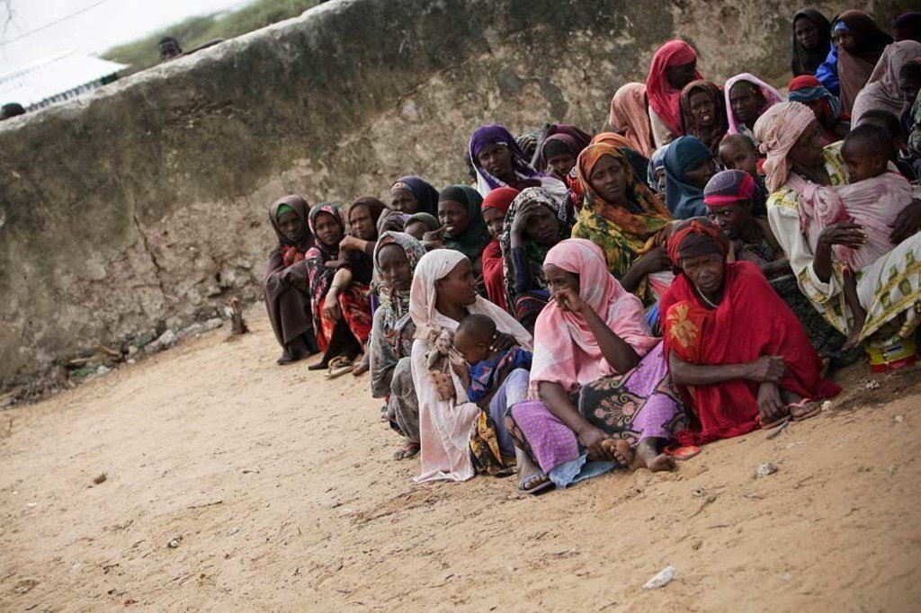 Internally Displaced Somalis wait for food distribution at the Badbado camp