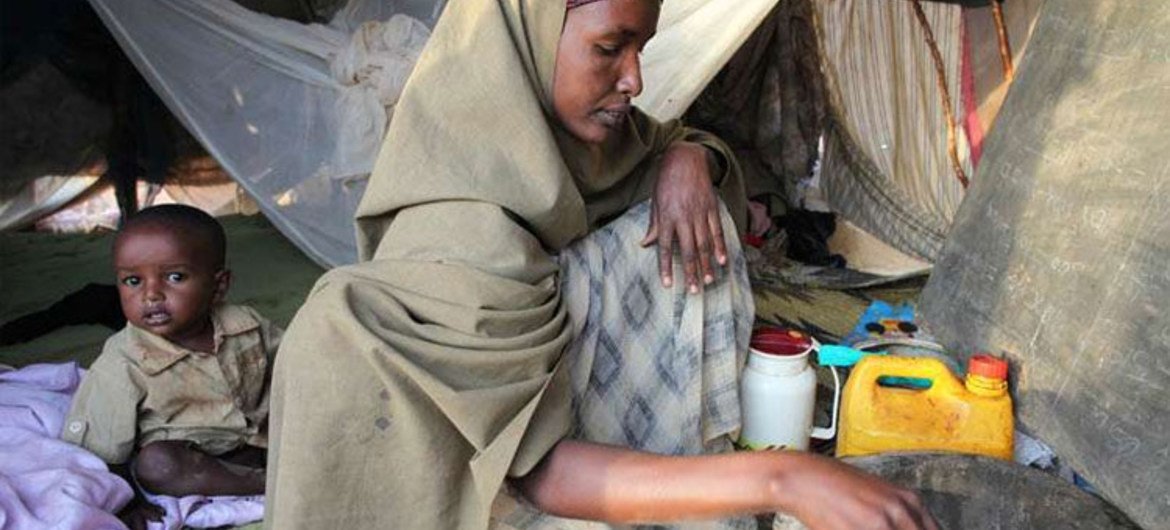 A refugee at camp Dabaad in Kenya prepares a meal for her family