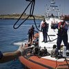 An Italian coastguard vessel, carrying 142 people rescued at sea after fleeing Tripoli, prepares to dock at Lampedusa harbour. (May 2011)