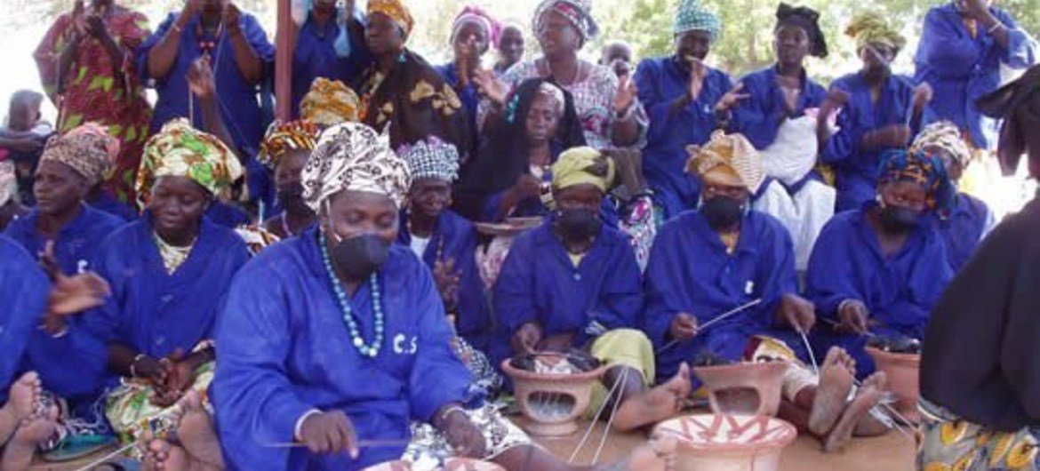 Women artisans in Mali making bracelets for sale to tourists using recycled plastic materials Women artisans in Mali making bracelets for sale to tourists using recycled plastic materials