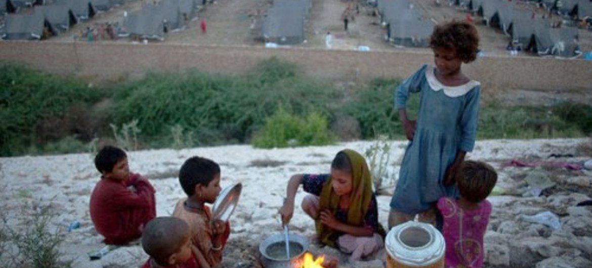 Children cook their daily meal in one of the 5,900 camps that sprung up across Pakistan in 2010 when the country was hit by the worst floods in its history.
