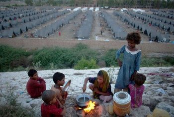 Des enfants préparent leur repas dans un des camps pour les personnes déplacées par des inondations au Pakistan en 2010.