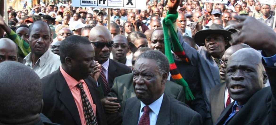 President Michael Sata of Zambia (centre) surrounded by supporters