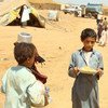 IDP children carrying food for their families in Mazraq One Camp, Yemen.