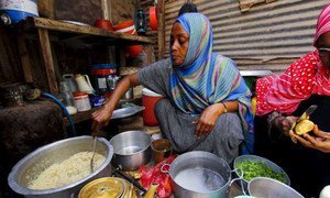 A Somali refugee cooks a meal for her family in Yemen