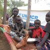 Sudanese refugees rest next to their UNHCR tent inside South Sudan