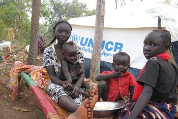 Sudanese refugees rest next to their UNHCR tent inside South Sudan