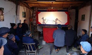 Shadow play being performed in the countryside alley in Anhui Province. © China Puppet and Shadow Art Society (2009)