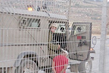 Israeli soldier arresting 12 year-old Palestinian youth at Nablus checkpoint