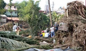 Residents of Mindanao, Philippines, survey damage caused by tropical storm Washi