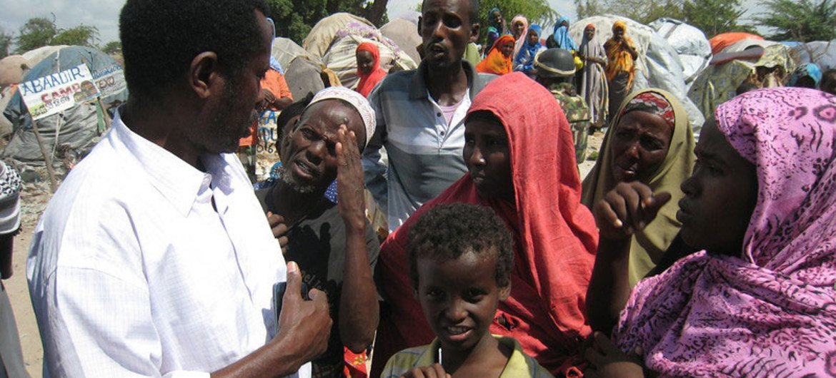 OCHA Humanitarian Affairs Officer Ahmed Farah Roble listens to IDPs at an IDP settlement in Mogadishu, Somalia