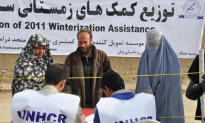 Vulnerable Afghan families line up to receive winter supplies in Dahsabz, a suburb of Kabul.