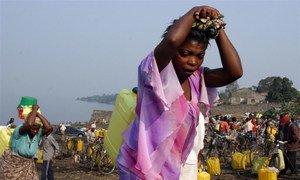 Women carry jerry cans of chlorinated water which is being used to contain cholera in eastern DRC.