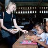 Jessica Watson distributes school lunches at a school on a visit to Laos in 2011.