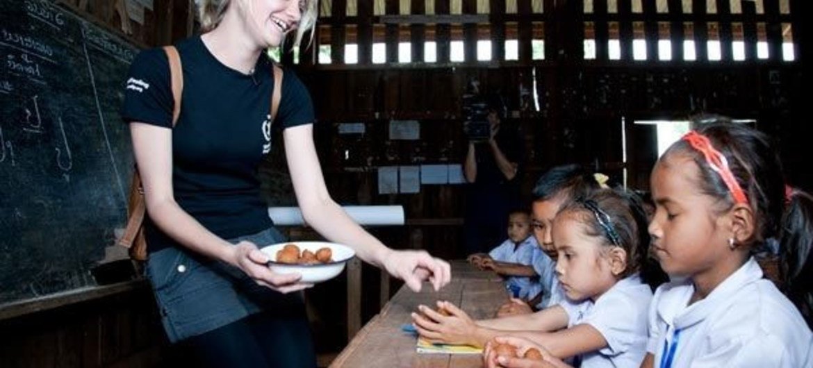 Jessica Watson distributes school lunches at a school on a visit to Laos in 2011.