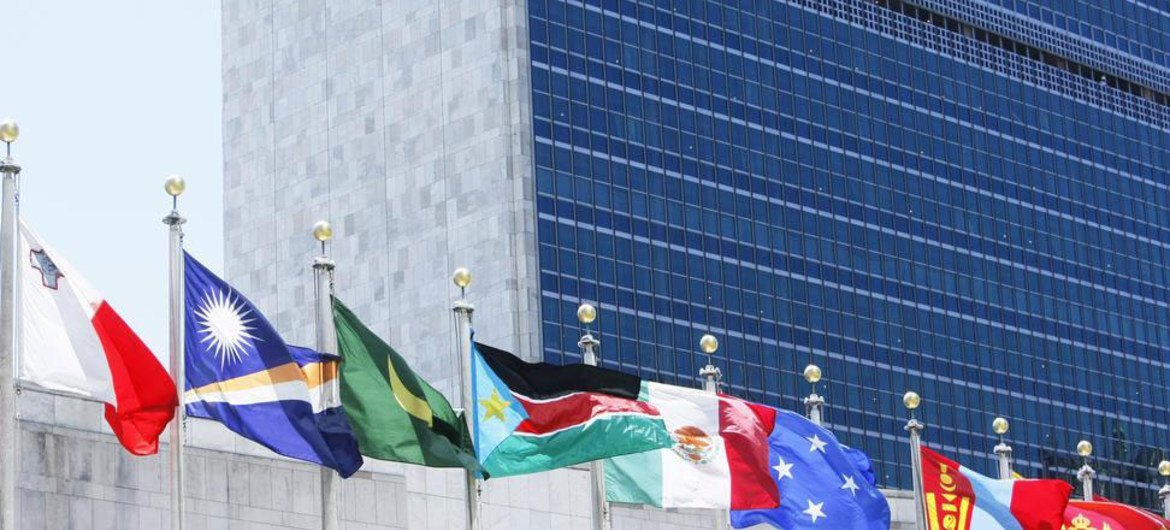 Flags of Member States fly in front of the United Nations Headquarters building.