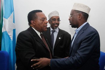 Special Representative Augustine Mahiga (left) greeting President Sheikh Sharif Sheikh Ahmed of Somalia in Mogadishu on 6 September 2011.