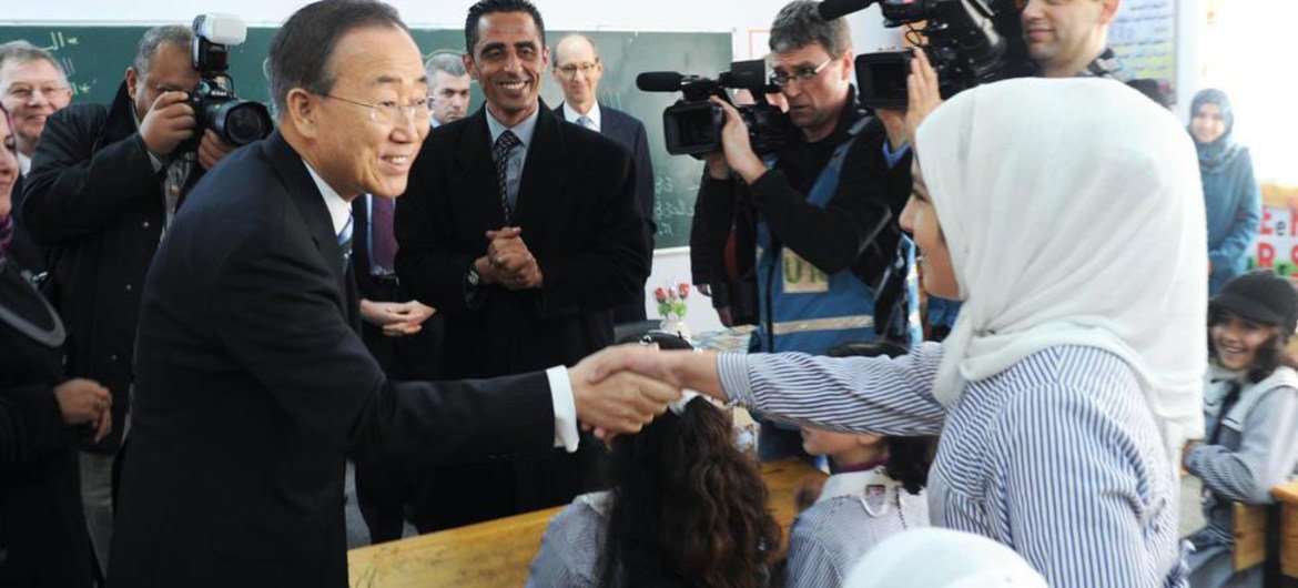 Secretary-General Ban Ki-moon (left) is greeted by a student during his visit to the school for girls run by UNRWA in Khan Younis, southern Gaza.