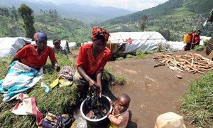 A Congolese woman washes clothes at a hillside camp for the internally displaced in North Kivu's Masisi District.
