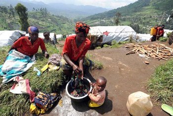 A Congolese woman washes clothes at a hillside camp for the internally displaced in North Kivu's Masisi District.