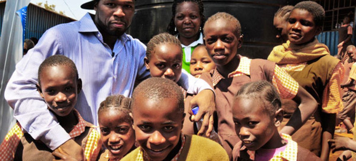 Rapper Curtis “50 Cent” Jackson with school kids in a Nairobi slum.