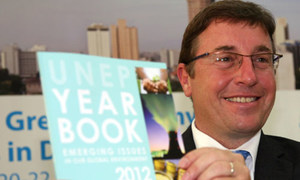 Executive Director Achim Steiner holds a copy of the UNEP Year Book.