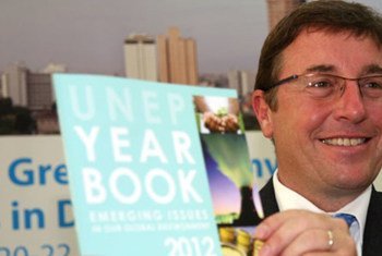 Executive Director Achim Steiner holds a copy of the UNEP Year Book.