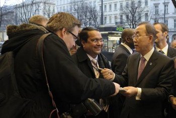 Secretary-General Ban Ki-moon (right) signs autographs for fans outside his hotel in Vienna, Austria.