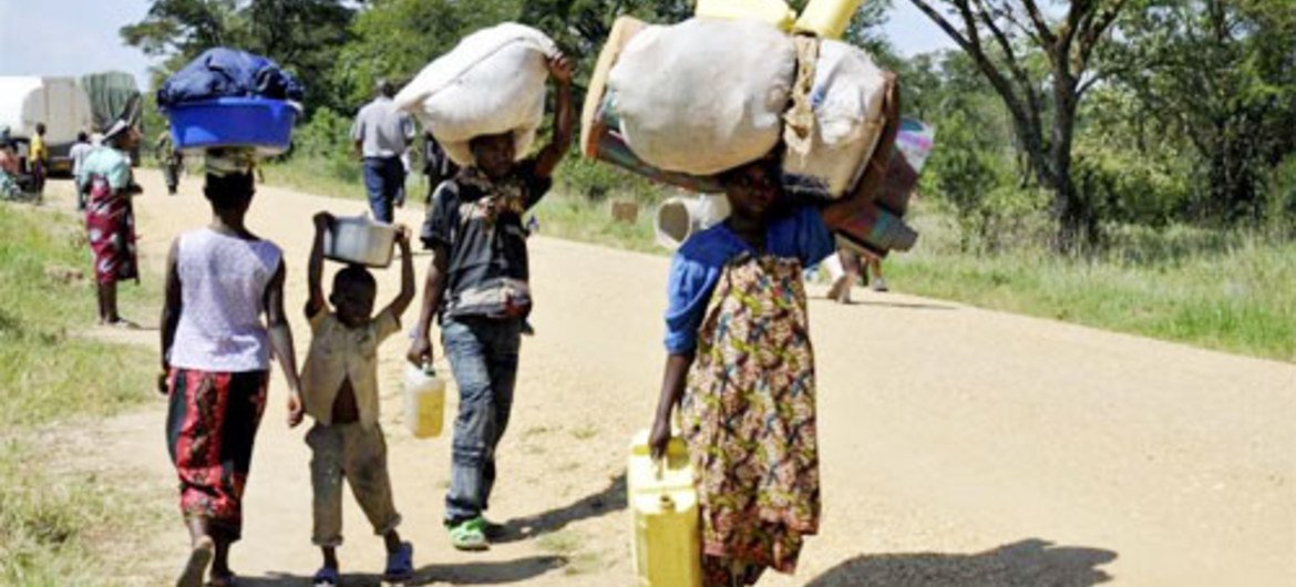 Villagers carry their belongings as they head towards the border with Uganda during an earlier exodus from North Kivu province.