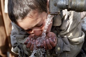 A young resident of Maslakh camp (Afghanistan) takes a drink of water.