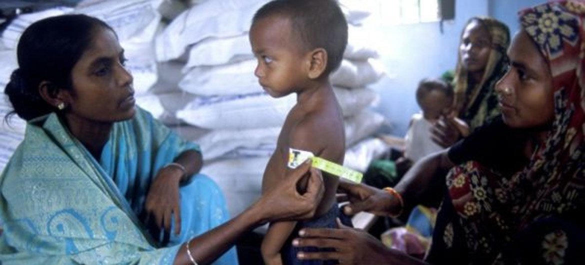 Child's arm being measured to assess his nutritional state at a feeding centre in Dahakula village, Bangladesh.