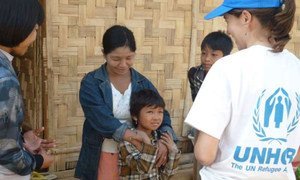 In a camp for internally displaced people in Kachin state, Myanmar, a family of five meets with a UNHCR staff.