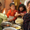 Displaced girls at Jalala camp collect food from a central distribution centre.