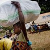 A Congolese woman, displaced by LRA attacks, carries a bag of non-food items distributed by UNHCR in Dungu, DR of Congo.