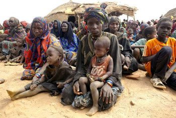 Malian refugee women wait with their children to receive relief items from UNHCR in Gaoudel, Ayorou district, northern Niger.