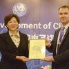 John E. Scanlon (right), CITES Secretary-General, presents Certificate of Commendation to Yin Hong, Vice Aministrator of State Forestry Administration in China.