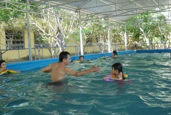 Water familiarisation in one of 10 SwimSafe portable pools in Danang, Viet Nam.